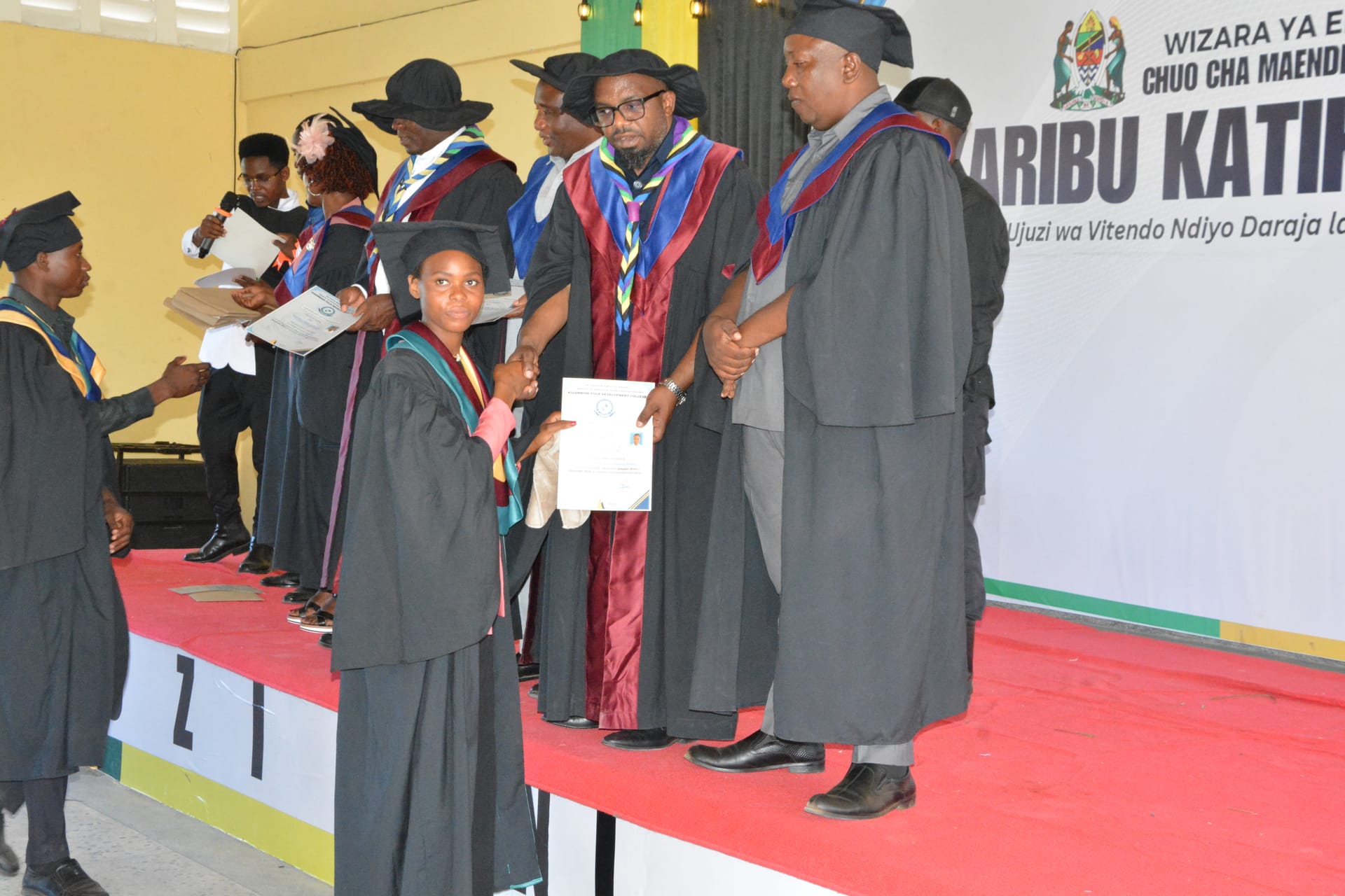EHM graduates receiving certificates at ceremony