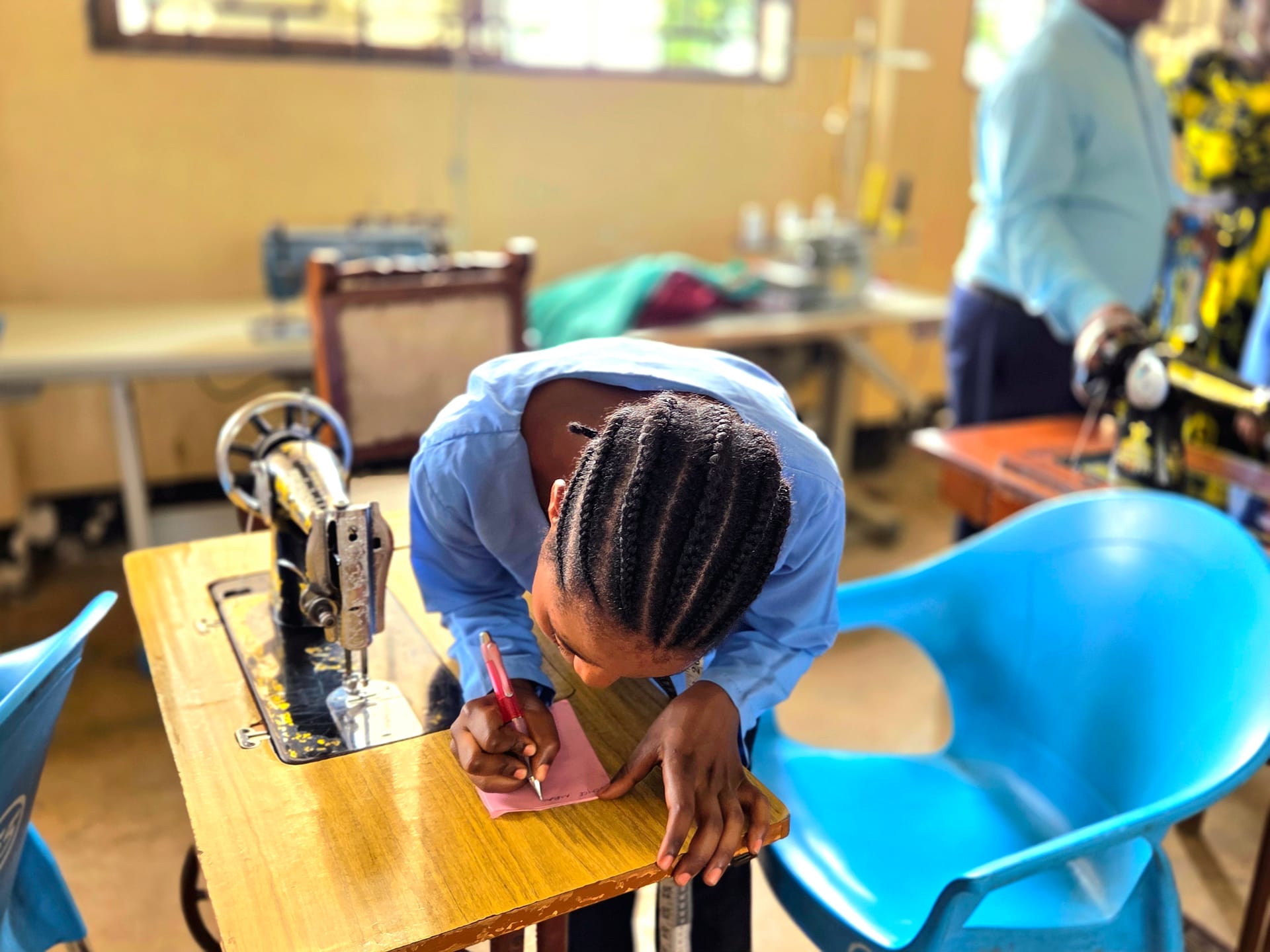 Young woman measuring fabric during vocational training