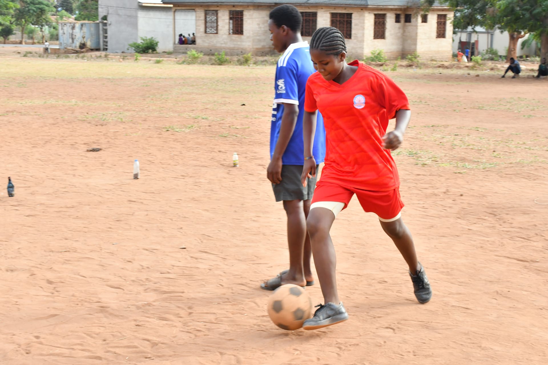 Primary school children participating in Mpira Fursa football